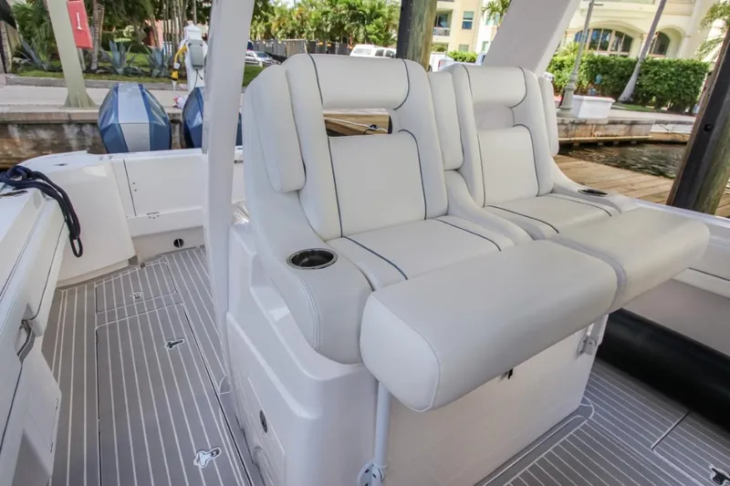 "alpha Bravo" Yacht Photos Pics 2022 Intrepid 375 Nomad SE boat interior with plush seating and cup holders.