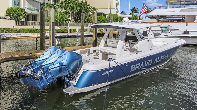 "alpha Bravo" Yacht Photos Pics 2022 Intrepid 375 Nomad SE boat docked, featuring triple outboard engines and sleek design.