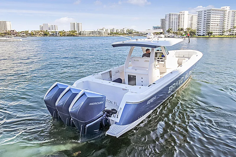 "alpha Bravo" Yacht Photos Pics 2022 Intrepid 375 Nomad SE boat cruising near city skyline.