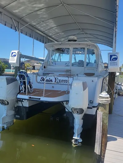 Yacht Photos Pics 2005 Glacier Bay 3480 Ocean Runner boat docked under canopy.