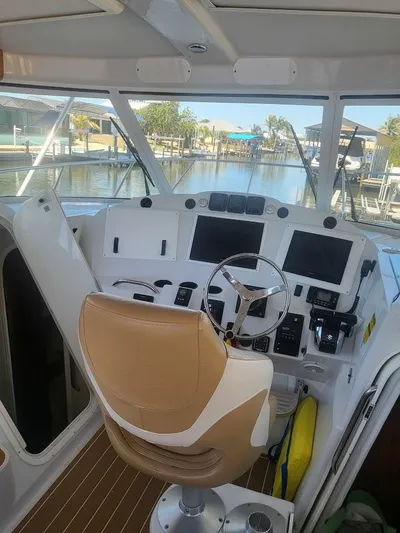  Yacht Photos Pics Interior view of 2005 Glacier Bay 3480 Ocean Runner boat cockpit with steering wheel and controls.