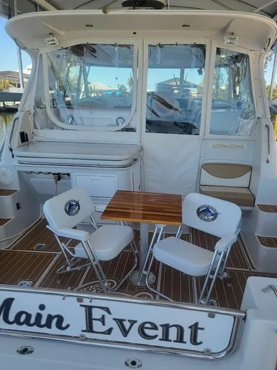  Yacht Photos Pics 2005 Glacier Bay 3480 Ocean Runner boat with seating area and table on deck.