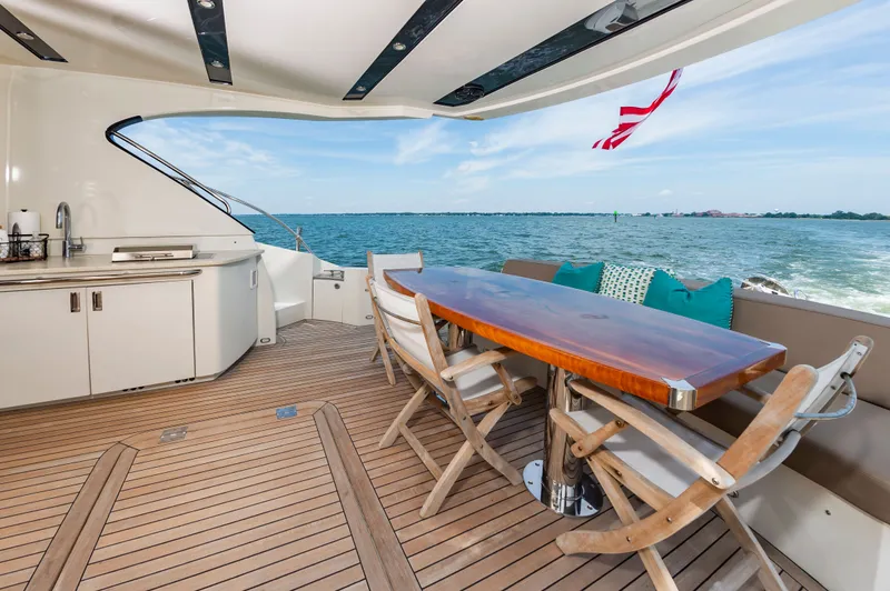 Docked Wages Yacht Photos Pics Luxurious 2013 Marquis 63 Sport Yacht deck with elegant seating and ocean view.