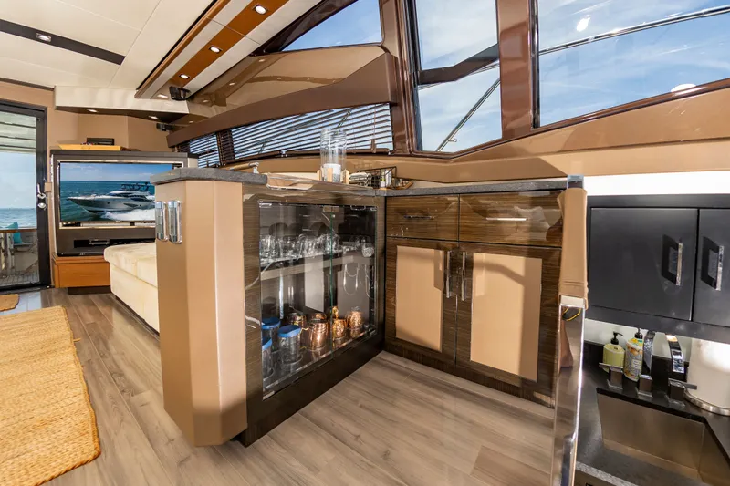 Docked Wages Yacht Photos Pics Luxurious interior of 2013 Marquis 63 Sport Yacht with modern cabinetry and glassware display.