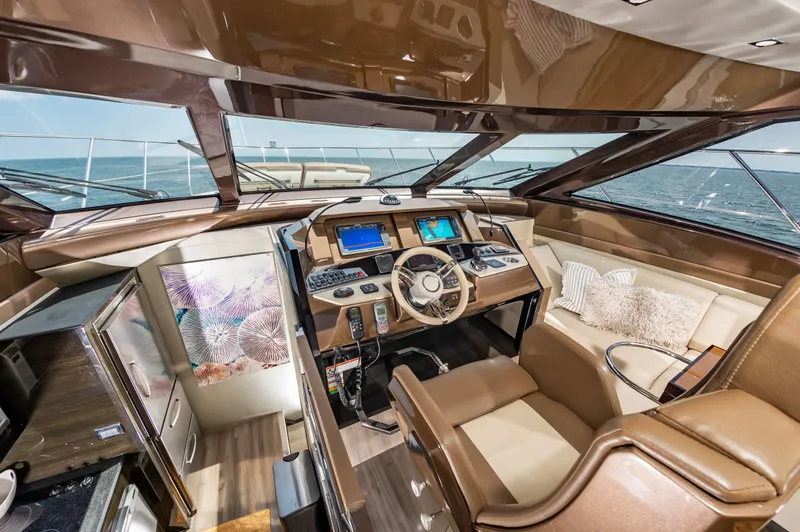 Docked Wages Yacht Photos Pics Luxurious interior of 2013 Marquis 63 Sport Yacht with modern helm and plush seating.