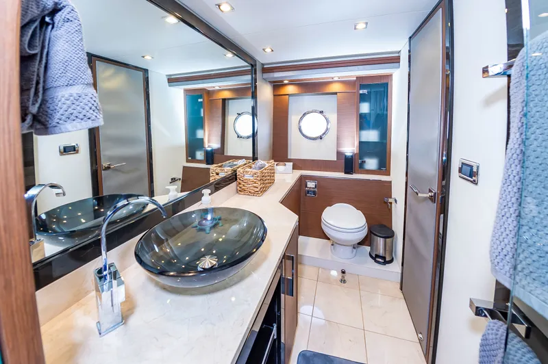 Docked Wages Yacht Photos Pics Luxurious bathroom interior of 2013 Marquis 63 Sport Yacht with modern fixtures and elegant design.