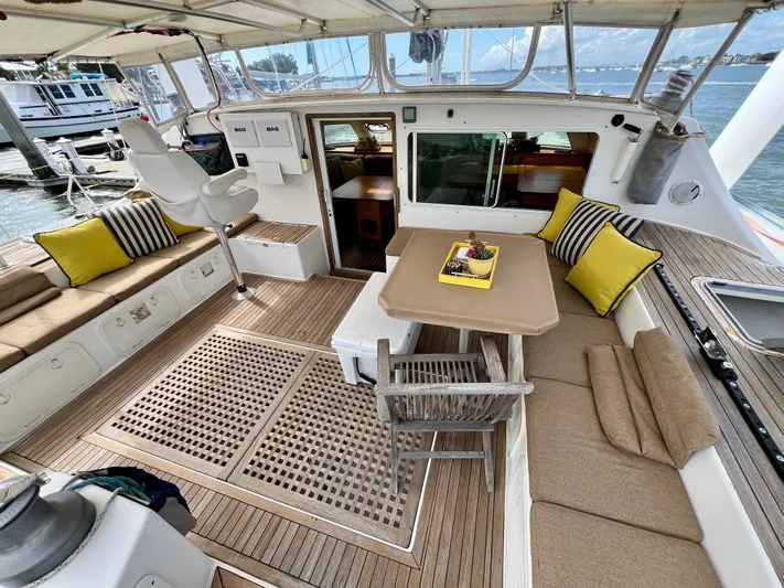 Trebuchet Yacht Photos Pics Spacious deck of a 2000 Switch 51 yacht with seating and table.