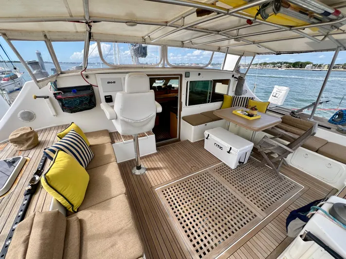 Trebuchet Yacht Photos Pics Spacious deck of a 2000 Switch 51 yacht with seating and dining area.
