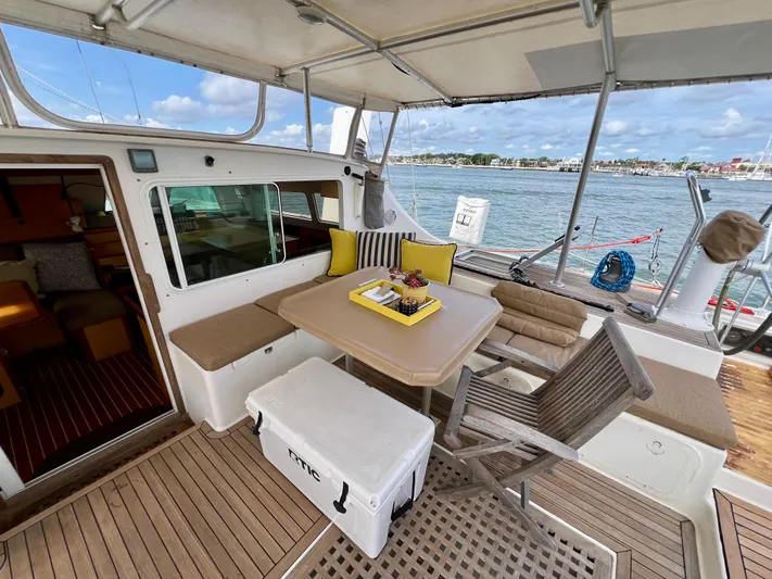 Trebuchet Yacht Photos Pics Outdoor seating area on a 2000 Switch 51 yacht with table, chairs, and ocean view.