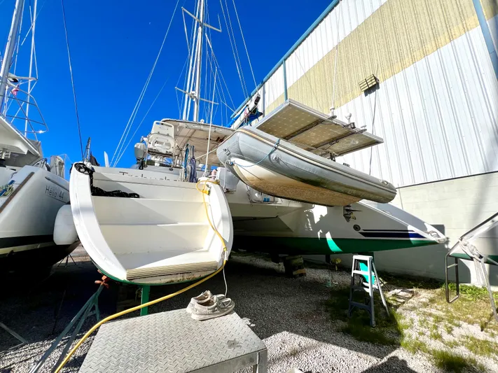 Trebuchet Yacht Photos Pics Catamaran Switch 51, year 2000, docked near a building under clear blue sky.