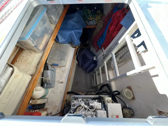 Trebuchet Yacht Photos Pics Boat storage compartment with ropes, tools, and engine, Switch 51 model, year 2000.