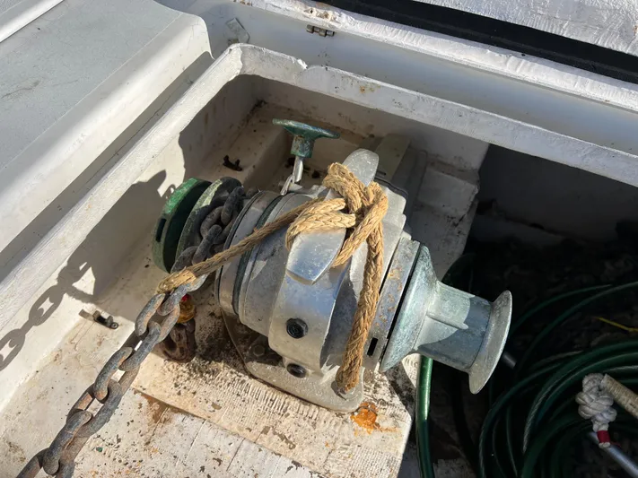 Trebuchet Yacht Photos Pics Old Switch 51 winch with rope and chain on a boat deck.