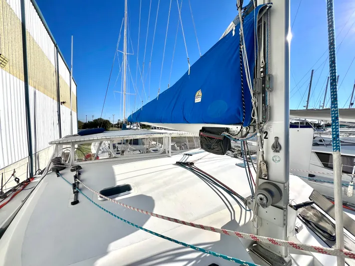Trebuchet Yacht Photos Pics Sailboat deck with blue sail, Switch 51 model, year 2000, docked under clear sky.