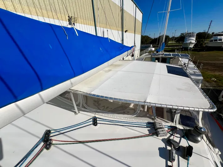 Trebuchet Yacht Photos Pics Sailboat deck with blue sail, Switch 51 model, year 2000, docked near a building.