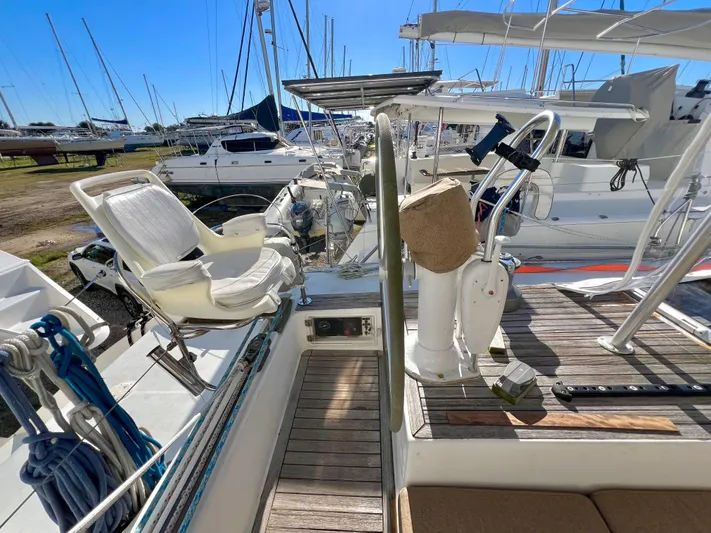 Trebuchet Yacht Photos Pics Sailboat deck with steering wheel, seating, and marina view; Switch 51, year 2000.