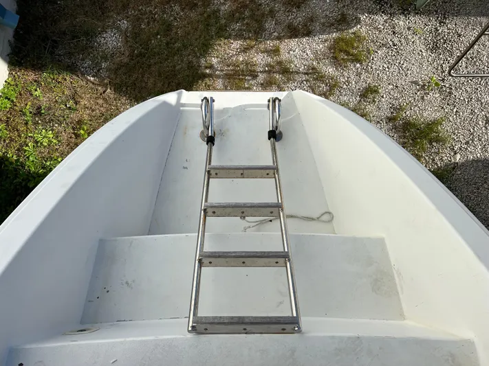 Trebuchet Yacht Photos Pics Boat ladder on a Switch 51, year 2000, with gravel and grass background.