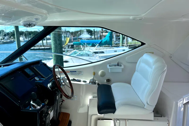  Yacht Photos Pics 2008 Tiara Yachts 3500 Sovran helm with white captain's chair and marina view.