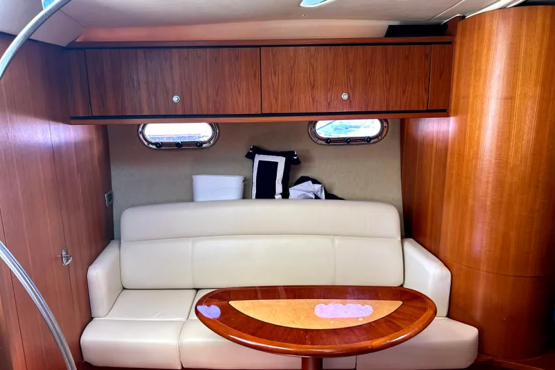  Yacht Photos Pics 2008 Tiara Yachts 3500 Sovran interior with cream sofa and wooden cabinetry.