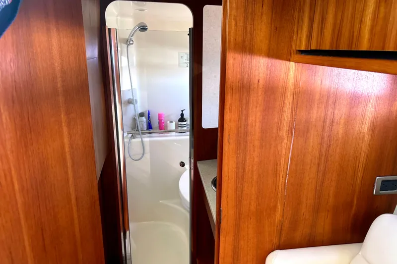  Yacht Photos Pics 2008 Tiara Yachts 3500 Sovran interior with wooden paneling and compact bathroom.