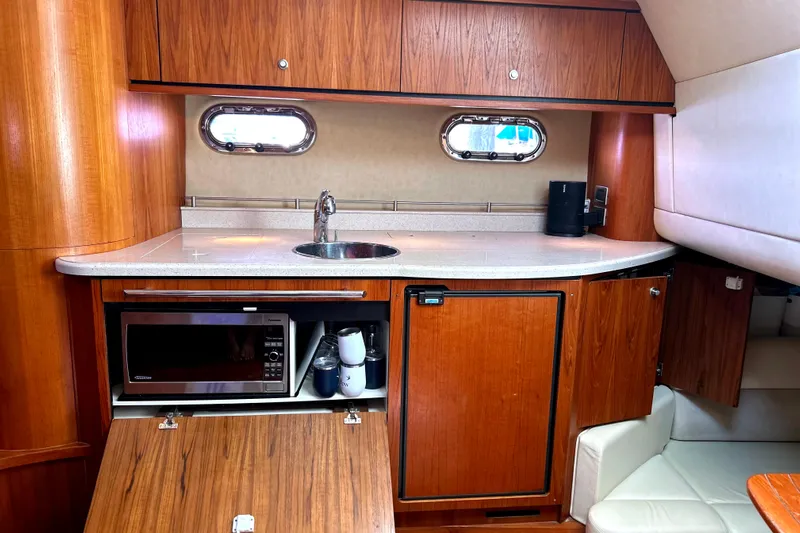  Yacht Photos Pics 2008 Tiara Yachts 3500 Sovran galley with wood cabinetry, sink, and microwave.