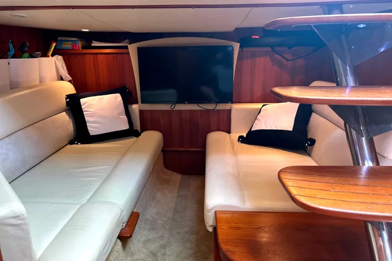 Yacht Photos Pics 2008 Tiara Yachts 3500 Sovran interior with white leather seating and wooden accents.