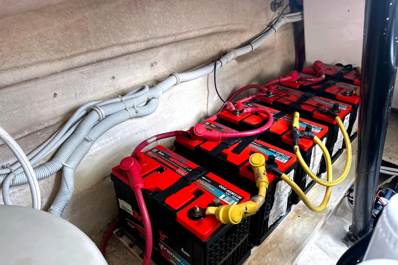  Yacht Photos Pics Battery compartment of a 2008 Tiara Yachts 3500 Sovran, featuring multiple red-topped batteries.