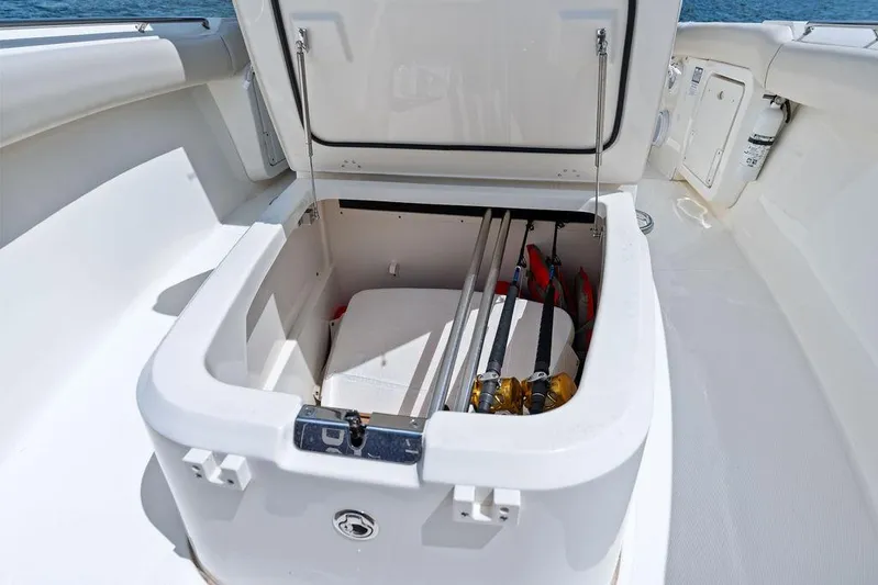 Zoom Yacht Photos Pics 2022 Boston Whaler 280 Outrage storage compartment with fishing rods and life jackets.