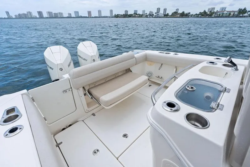 Zoom Yacht Photos Pics 2022 Boston Whaler 280 Outrage boat interior with seating and dual Mercury engines.