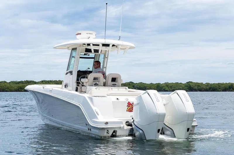 Zoom Yacht Photos Pics 2022 Boston Whaler 280 Outrage boat on water, featuring dual outboard engines.