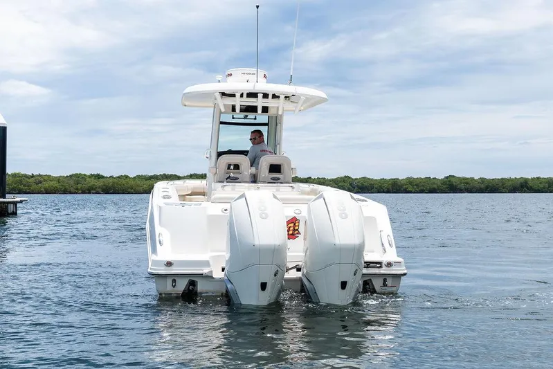 Zoom Yacht Photos Pics 2022 Boston Whaler 280 Outrage boat on water, rear view with dual engines.