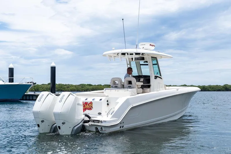 Zoom Yacht Photos Pics 2022 Boston Whaler 280 Outrage boat with dual engines on calm water.