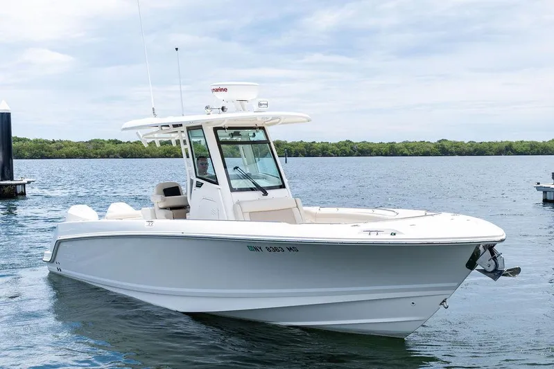 Zoom Yacht Photos Pics 2022 Boston Whaler 280 Outrage boat on calm water, featuring sleek design and modern amenities.