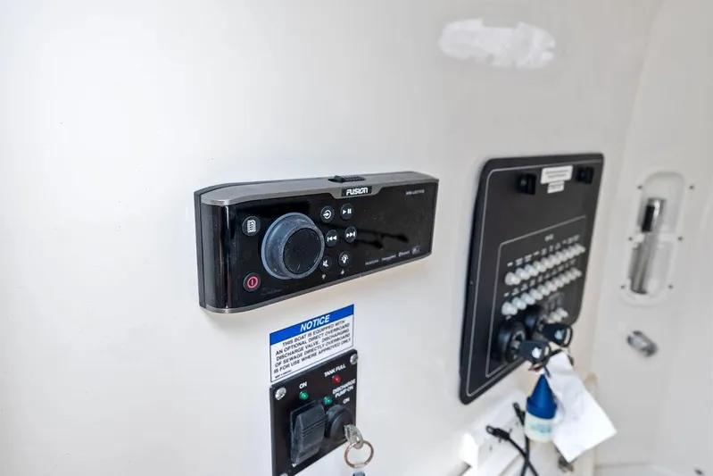 Zoom Yacht Photos Pics Control panel of a 2022 Boston Whaler 280 Outrage boat, featuring a Fusion audio system.
