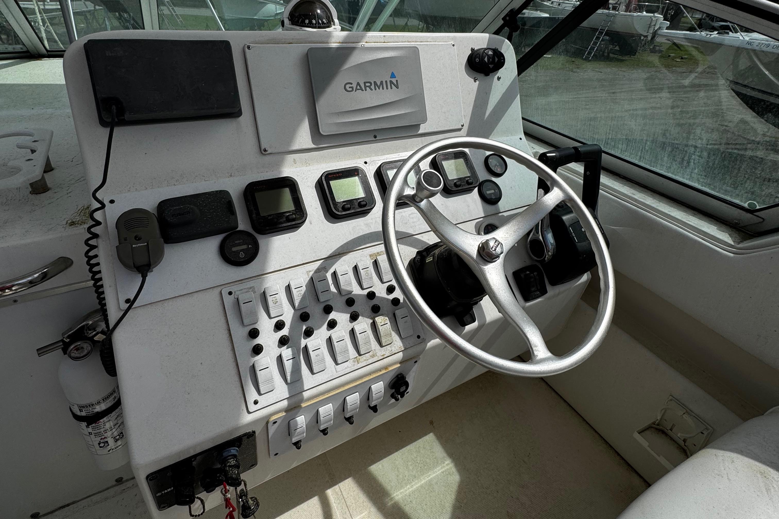 Control panel of a 2001 Stamas 310 Express boat with Garmin navigation system.