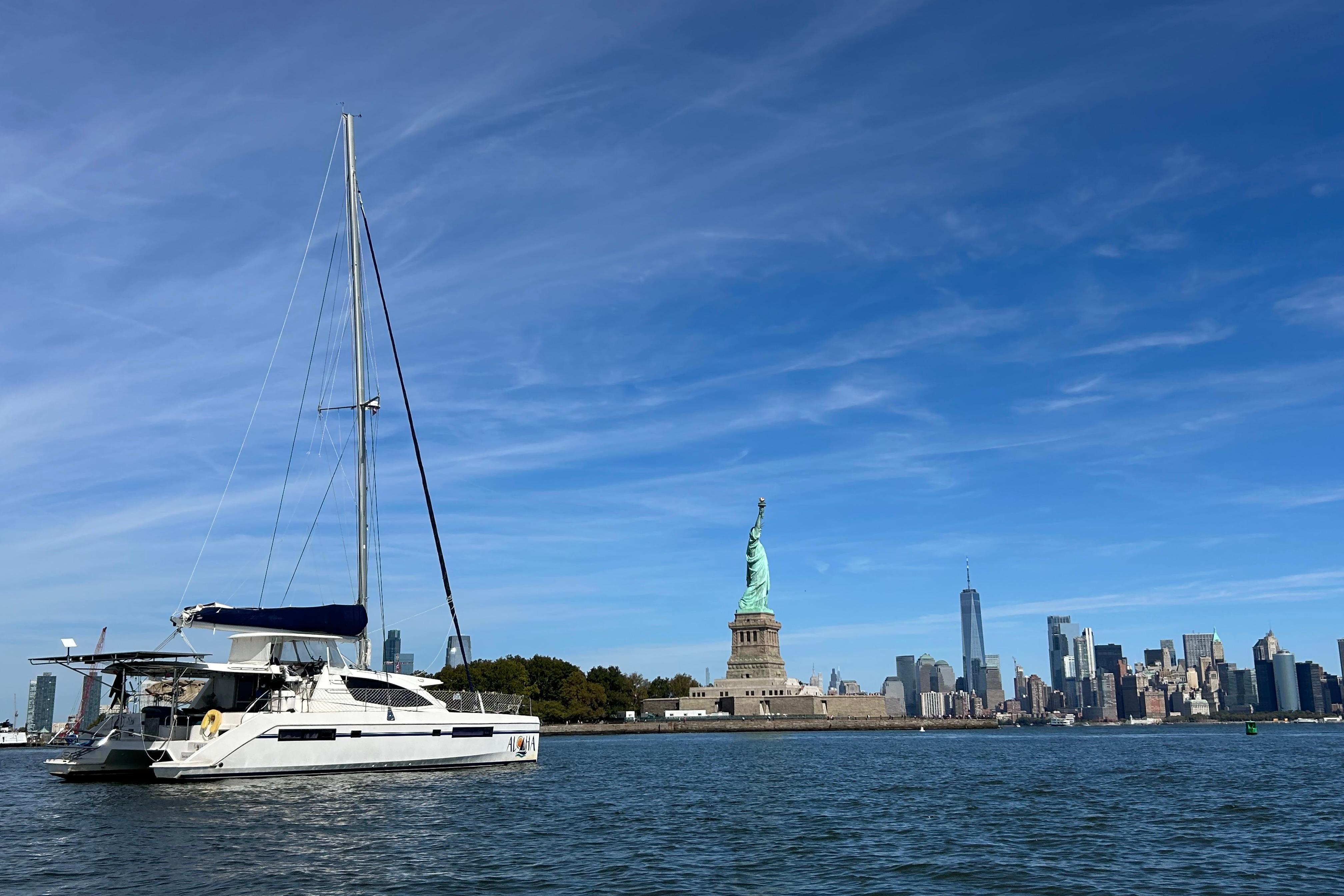 Leopard 48 yacht near Statue of Liberty with New York City skyline, 2013 model.
