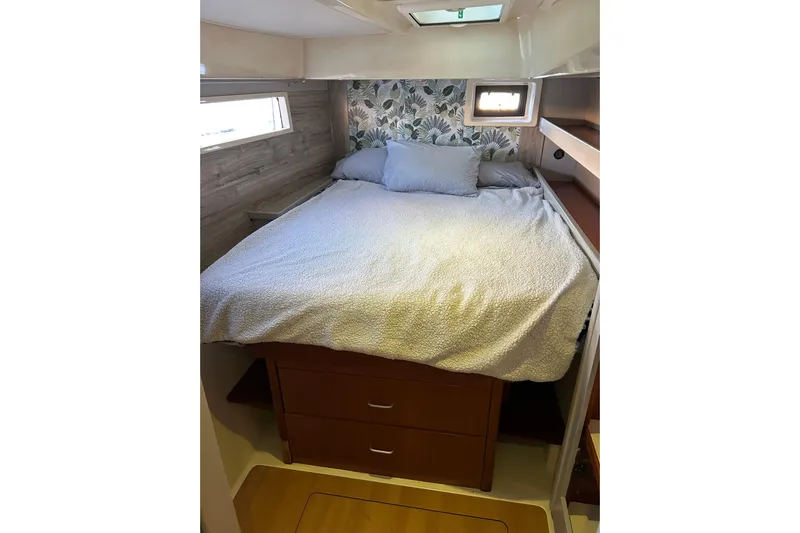  Yacht Photos Pics Cozy bedroom in 2013 Leopard 48 yacht with floral wallpaper and storage drawers.