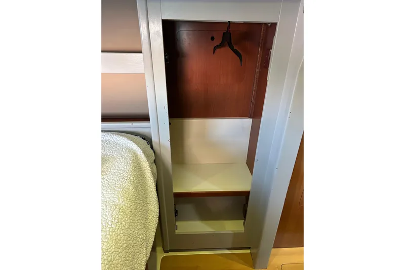  Yacht Photos Pics Empty closet in 2013 Leopard 48 yacht interior with wooden finish and hanger.