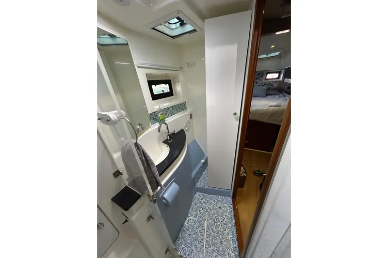  Yacht Photos Pics Bathroom interior of 2013 Leopard 48 yacht with modern fixtures and patterned flooring.