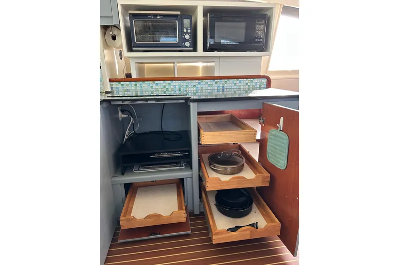  Yacht Photos Pics Kitchen area in a 2013 Leopard 48 yacht with appliances and storage drawers.