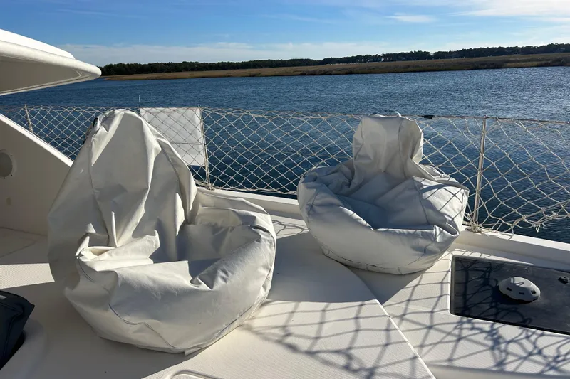  Yacht Photos Pics Two white bean bag chairs on a 2013 Leopard 48 yacht deck by the water.