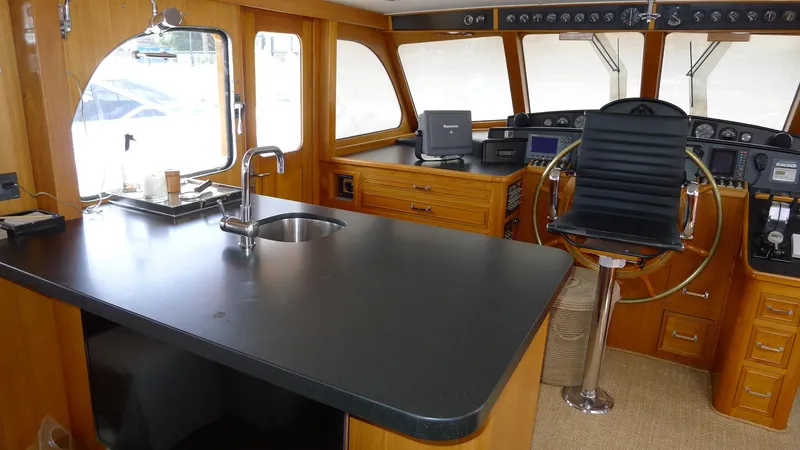 Dakota Yacht Photos Pics Interior of 1953 De Vries Lentsch 68 Motoryacht with helm and kitchen area.