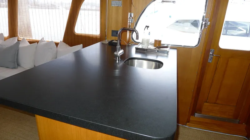 Dakota Yacht Photos Pics Interior of 1953 De Vries Lentsch 68 Motoryacht with modern kitchen counter and sink.