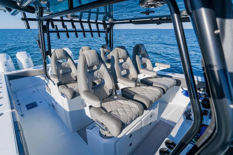 Reel Blessed Yacht Photos Pics Luxurious seating on 2025 Freeman 42LR boat, ocean backdrop, modern design.
