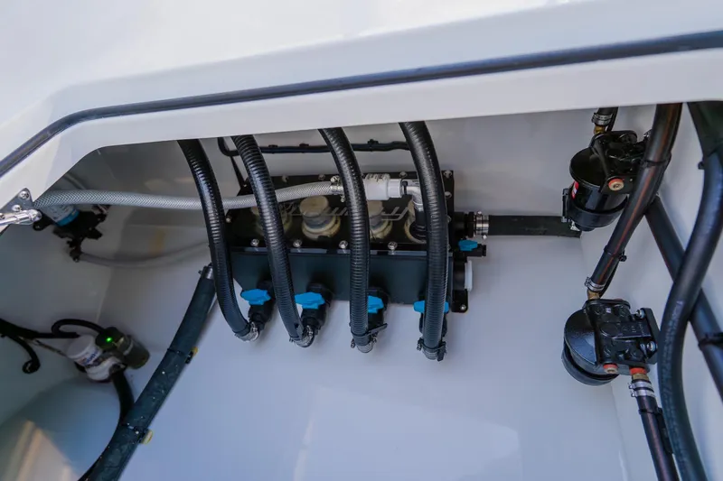 Reel Blessed Yacht Photos Pics Freeman 42LR 2025 boat engine compartment with hoses and mechanical components.