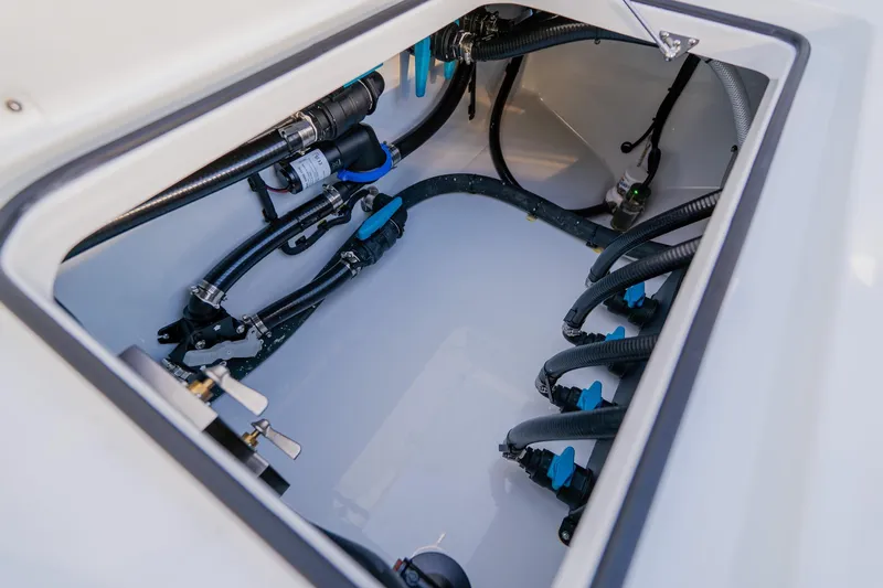 Reel Blessed Yacht Photos Pics Engine compartment of 2025 Freeman 42LR boat, showcasing hoses and mechanical components.