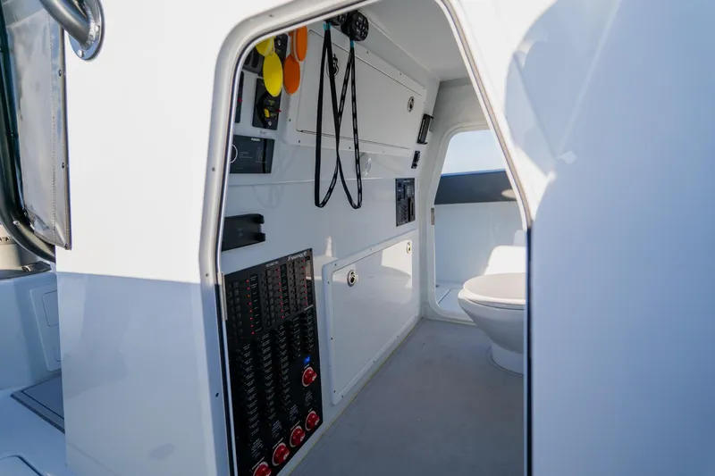 Reel Blessed Yacht Photos Pics Interior of 2025 Freeman 42LR boat showing control panel and compact restroom.