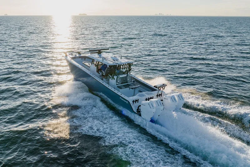 Reel Blessed Yacht Photos Pics 2025 Freeman 42LR boat cruising on open water at sunset.