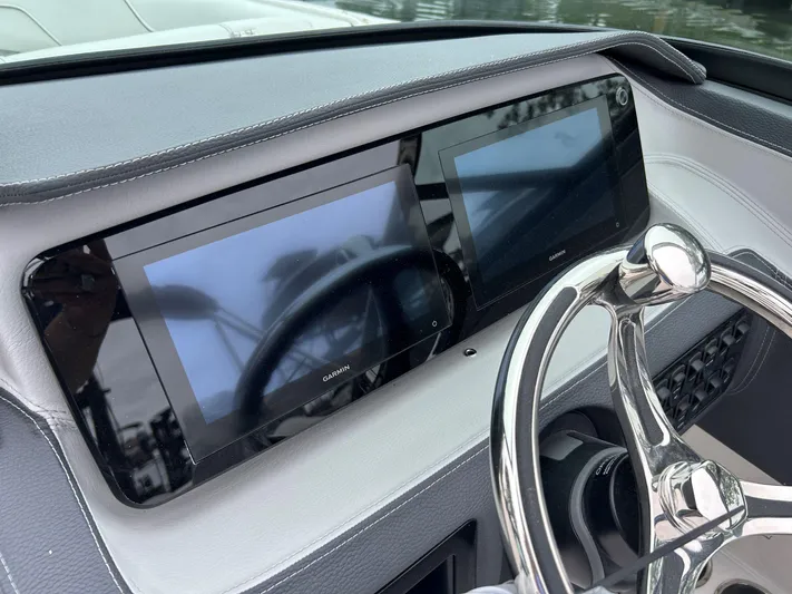  Yacht Photos Pics 2026 Regal LX4 boat dashboard with dual Garmin displays and sleek steering wheel.