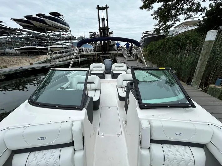  Yacht Photos Pics 2026 Regal LX4 boat docked, featuring sleek white seating and dual windshields.
