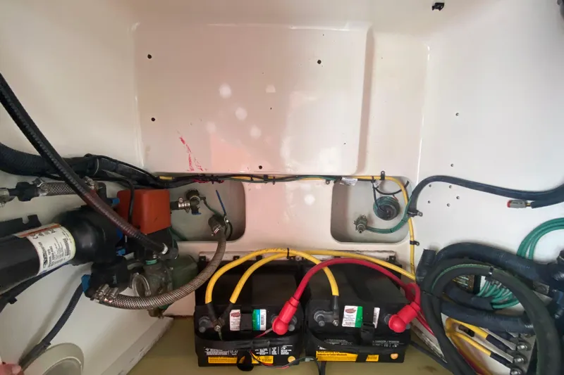  Yacht Photos Pics Engine compartment of a 2006 Pursuit 3480 Drummond Island Runner with visible wiring and batteries.